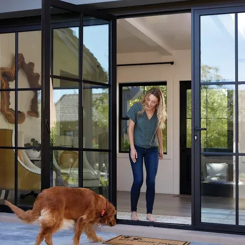 Woman and dog in front of new windows and door